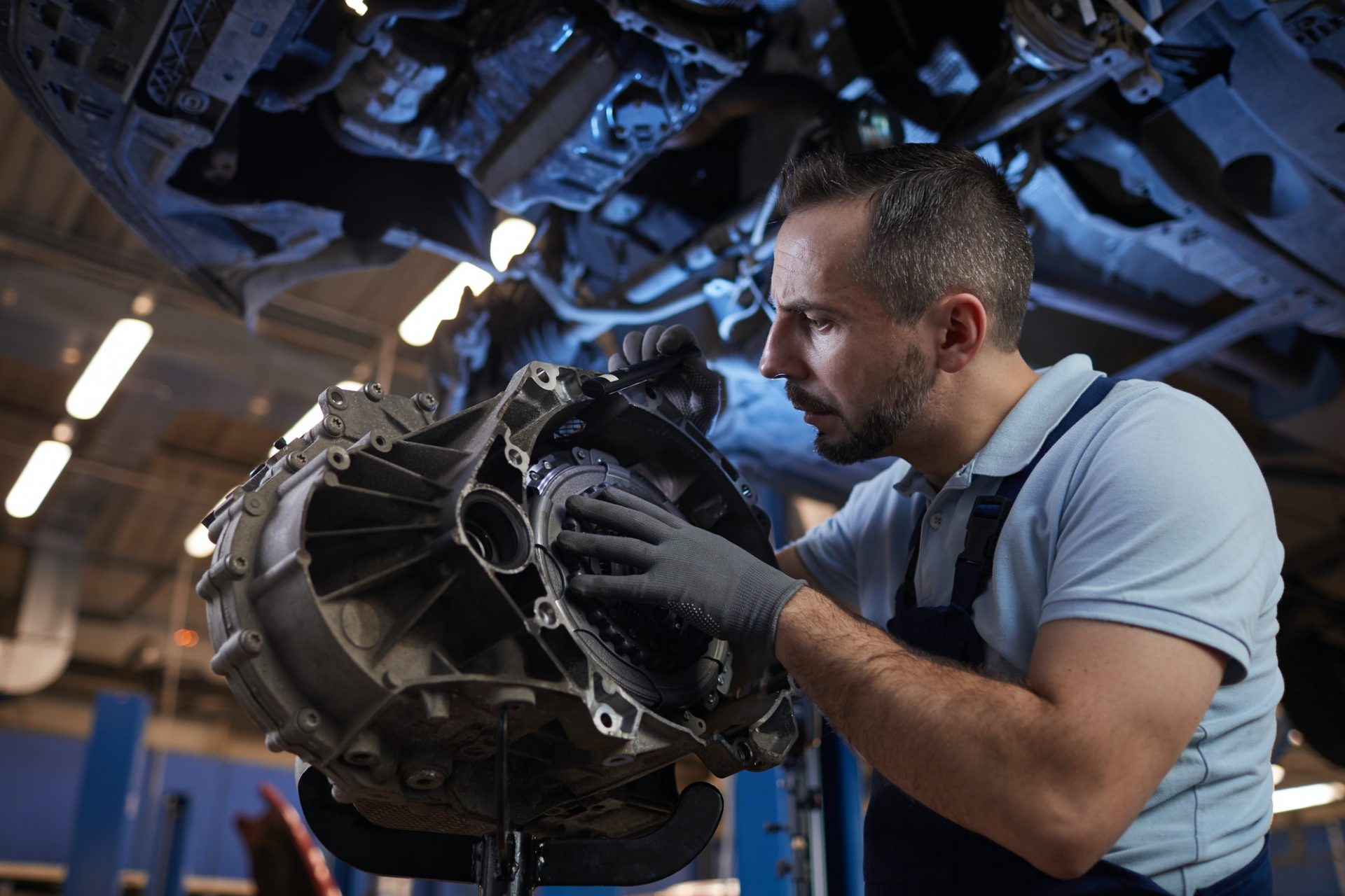 auto mechanic fixing car on lift e1609042301246