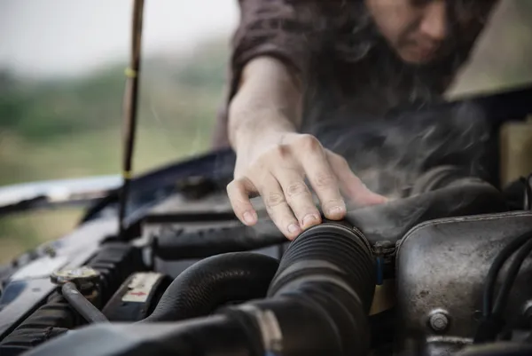vecteezy_man try to fix a car engine problem on a local road chiang_8749468_result